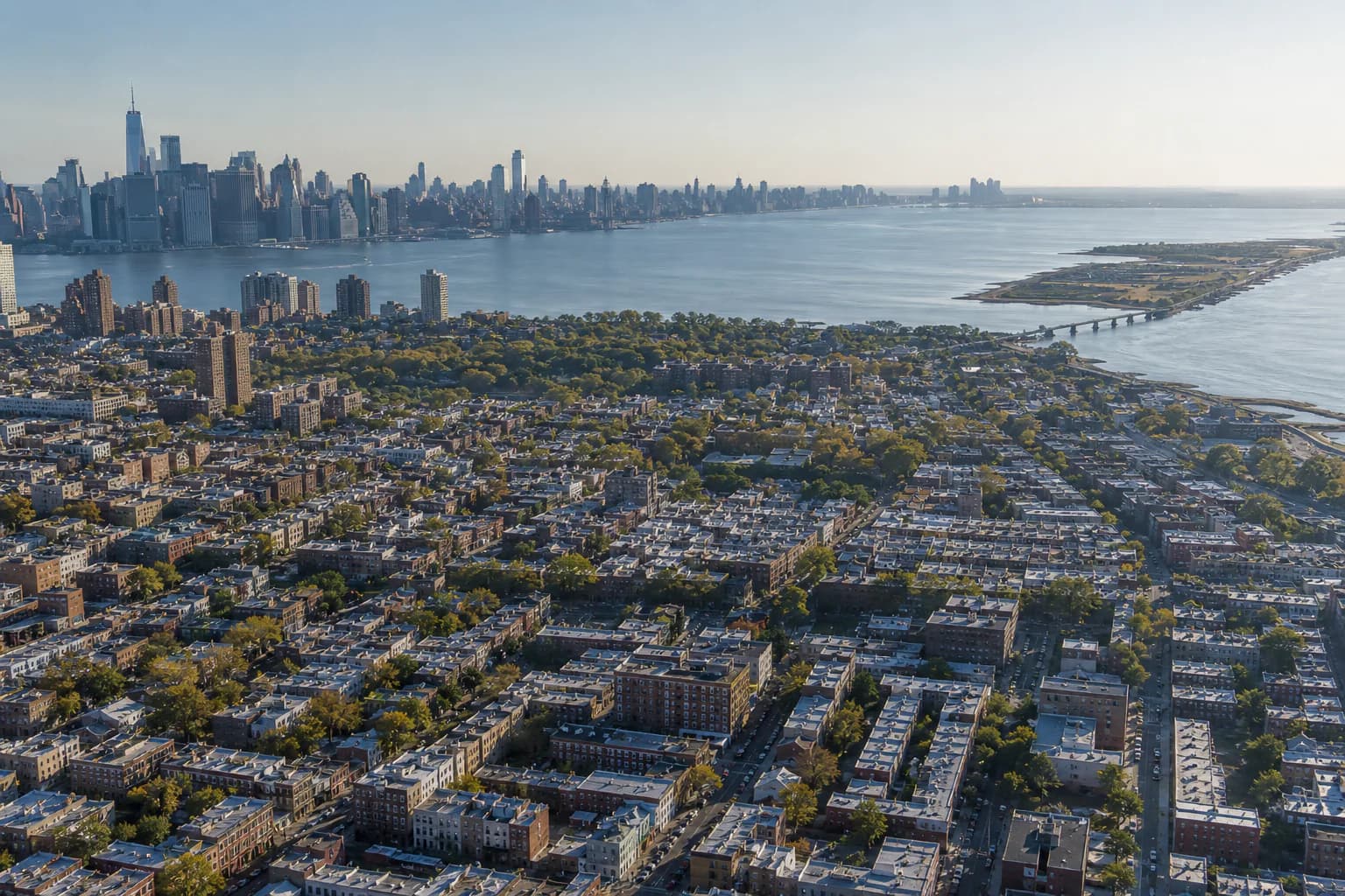 Aerial view across New York City neighborhoods and surrounding waterfront